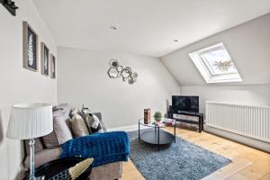 a living room with a couch and a table at One-bed central retreat in Brockenhurst in Brockenhurst