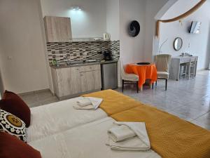 a bedroom with a large bed and a kitchen at Apollonio Suites & Rooms Faliraki Rhodes in Faliraki