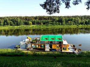 a boat is docked on a river at Nemo Keliones in Druskininkai