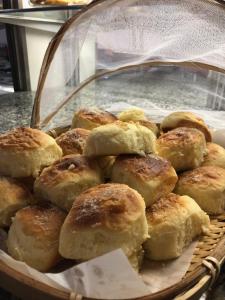 a basket of pastries in a display case at Pousada Central in Feira de Santana