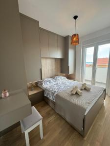 a bedroom with a bed with two towels on it at Apartment Mimi in Zadar