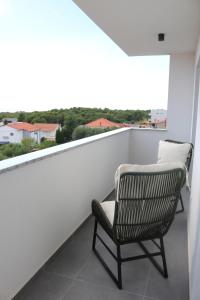 a rocking chair on a balcony with a view at Apartment Mimi in Zadar