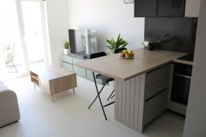 a kitchen with a table with a bowl of fruit on it at Apartment Mimi in Zadar +7 photos
