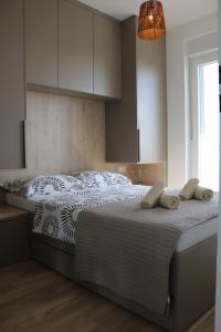 a bedroom with a large bed with white sheets at Apartment Mimi in Zadar
