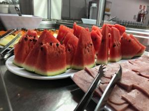 a plate of watermelon slices on a counter at Pousada Central in Feira de Santana