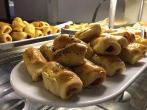 a plate of dumplings sitting on a table at Pousada Central in Feira de Santana