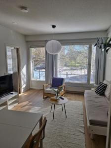 a living room with a couch and a table at Cozy one-bedroom apartment with sauna in Rauma +27 photos