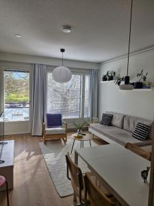a living room with a couch and a table at Cozy one-bedroom apartment with sauna in Rauma