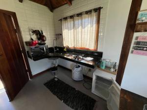 a kitchen with a sink in a room at Chalé Lírio do Campo in Lavras Novas