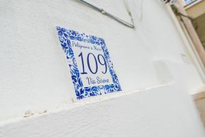 a blue and white sign on the side of a building at BVsireneHOUSE in Polignano a Mare
