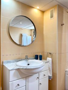 a bathroom with a sink and a mirror at Atico luminoso en Cullera centro. in Cullera +22 photos