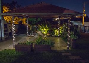 a gazebo with lights in a yard at night at GinKgo B&B in Francavilla al Mare +25 photos