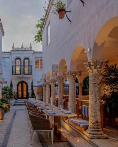 a row of tables and chairs in a building at Donatella Boutique Hotel in Miami Beach