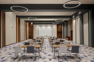 a conference room with tables and chairs and a projection screen at Courtyard by Marriott Casablanca Downtown in Casablanca +86 photos