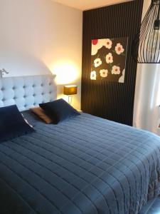 a bedroom with a blue bed with a blue comforter at J in Kreuztal