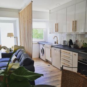 a kitchen with white cabinets and a blue counter top at Casinha de santo Antonio in Villa Nogueira