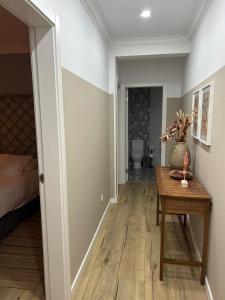 a room with a table and a bed and a bathroom at Casinha de santo Antonio in Villa Nogueira +59 photos
