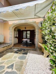 an outdoor patio with an archway and a table at Appartamento le querce in Vaccileddi