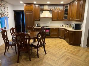 a kitchen with a table and chairs in a room at Wind Mood in Klebiškis