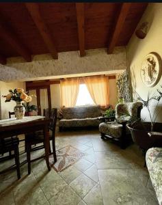 a living room with a table and a window at Jenny's House b&b in Presenzano