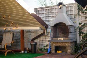 a outdoor fireplace in the backyard of a house at Apartament ARKON in Hermanowa
