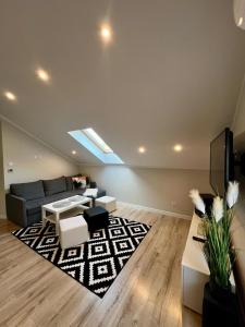 a living room with a couch and a rug at Apartament ARKON in Hermanowa