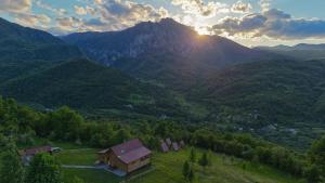an aerial view of a valley with a barn and mountains at Mountain Camp Outdoor Tara in Tjentište