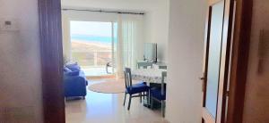 a living room with a dining room table and a view of the ocean at Apartamento Aiguablava Playa de Gandía in Playa de Gandia