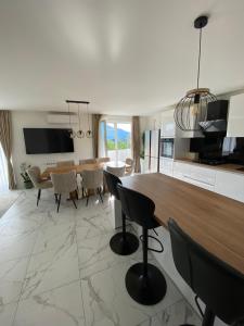 a kitchen and dining room with a table and chairs at Emily in Slime