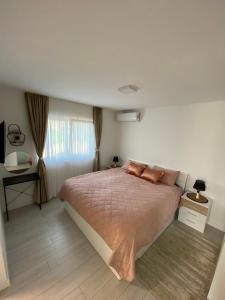 a bedroom with a large bed with two pillows at Emily in Slime