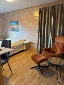 a room with a bed and a table and chairs at Fjordutsikten Camping AS in Lakselv