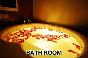 a bath room with a bowl with red sprinkles on it at Hotel Balian Resort Chiba - Family Kids Group Concept in Chiba