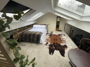 a bedroom with a bed and a table in it at LiverpoolPenny Lane in Liverpool