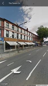 an empty street with arrows on the side of a building at LiverpoolPenny Lane in Liverpool