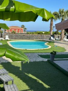 a swimming pool in a yard with a bench at La Casa Delle Conchiglie in Catania