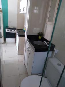 a small bathroom with a sink and a toilet at Maracaípe Cantinho Vida Boa in Porto De Galinhas