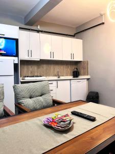 a kitchen with a table with a remote control on it at Seten House in Urgup