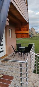 a patio with a bench and a table in front of a building at Planinski san in Žabljak