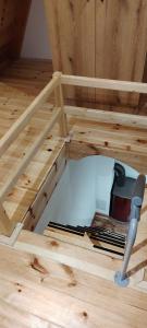 a loft bed with a tool on the floor at Planinski san in Žabljak +5 photos