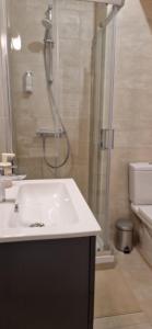 a bathroom with a sink and a shower at Gare a pied Escale Authentique aux Portes de Paris in La Ferté-sous-Jouarre