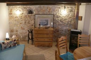 波梅爾的住宿－Lovely Stone Cottage Pomer，客厅设有木制梳妆台和石墙