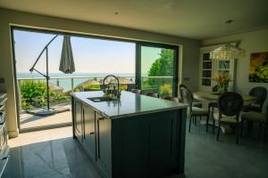 a kitchen and dining room with a view of the ocean at Spacious home with amazing views in Folkestone