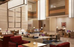 a lobby of a hotel with tables and chairs at Taj Bangalore in Devanahalli-Bangalore