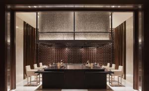 a kitchen with a sink and a bunch of chairs at Taj Bangalore in Devanahalli-Bangalore