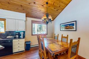 a kitchen and dining room with a wooden table at Ollie's Place in Breckenridge