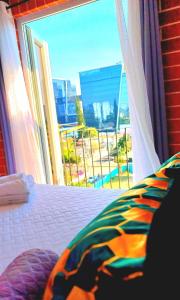 una camera da letto con un letto e una grande finestra di F8 Deluxe Suite Ciudad de Guatemala, zona 10 a Guatemala