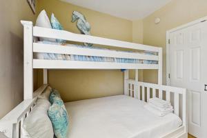 a white bunk bed in a childs bedroom at Down the Shore in Gulf Shores +23 photos