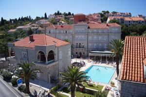 an aerial view of a large building with a swimming pool at Hotel Lapad in Dubrovnik