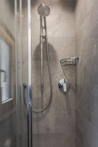 a shower with a glass door in a bathroom at Villa Resi B&B in Corvara in Badia