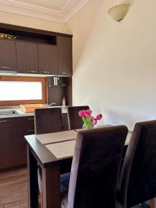 a dining room table with chairs and a vase of flowers at Casablanca in Sutomore +20 photos